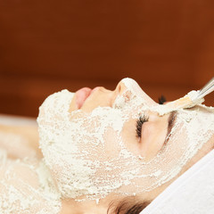 chemic facial peel mask. Cosmetology acne treatment. Young girl at medical spa salon. Brush. Face...