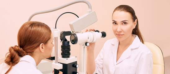 ophthalmologist doctor in exam optician laboratory with female patient. Eye care medical diagnostic. Eyelid treatment
