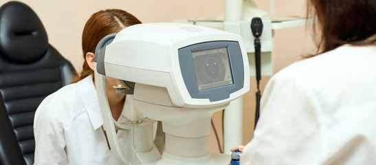 ophthalmologist doctor in exam optician laboratory with female patient. Eye care medical...