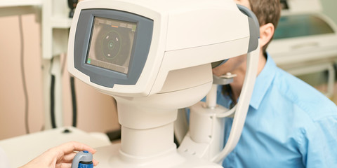 ophthalmologist doctor in exam optician laboratory with male patient. Men eye care medical diagnostic. Eyelid treatment