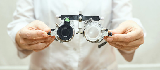 ophthalmologist doctor in exam optician laboratory with female patient. Eye care medical...