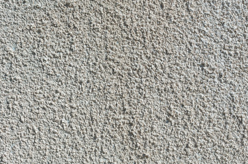 Coarse-grained textured gray background cement finish of the building facade with cement putty