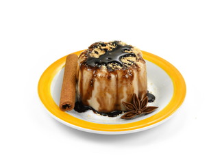 Hazelnut caramel pudding sprinkled with ground biscuits isolated on white background.