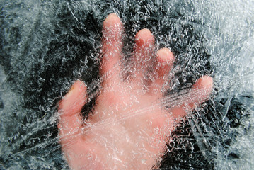 Hand under a layer of ice. Man under the ice. Save the drowning under the ice.