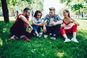 Fototapeta na wymiar Male and female teenagers in casual clothing handing out together at park