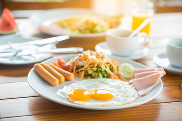 Breakfast, sausage, Fried eggs with salad on the table. Selective focus.