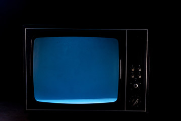 Static noise on a vintage TV set in black background - obrazy, fototapety, plakaty