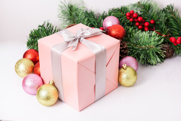 Fototapeta na wymiar Beautiful pink gift box with Christmas ornaments on white background