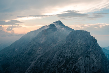 Obraz na płótnie Canvas Prisojnik mountain view landscape in Julian Alps in Slovenia, near Vršič pass, look from Razor mountain in cloudy weather, sunset time