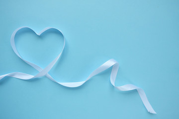 white ribbon in the shape of a heart