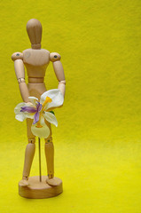 A wooden mannequin with a white African iris