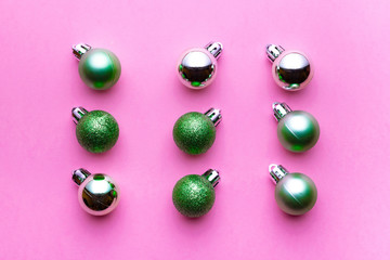 Xmas background. Christmas decoration balls isolated on pink. Abstract winter concept. Flat lay