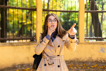 Fototapeta premium Young beautiful female dreaming in the autumn park.