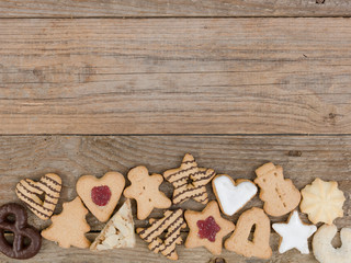 many different nice christmas cookies on wooden background photo taken from above