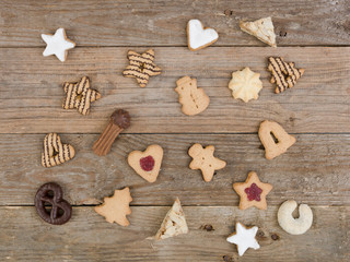many different nice christmas cookies on wooden background photo taken from above