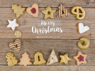many different nice christmas cookies on wooden background photo taken from above