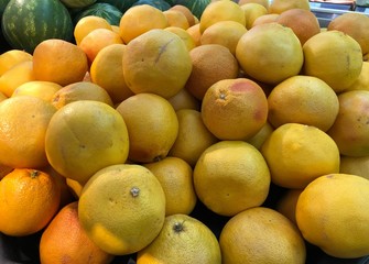 Pile of oranges and watermelons at a fruit stall