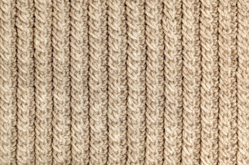 Knit texture of beige wool knitted fabric with cable pattern as background