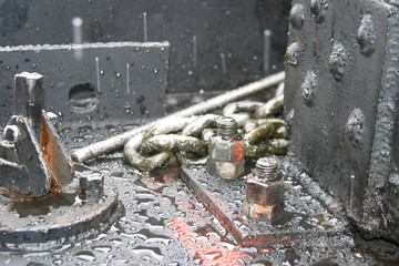 Steam locomotive details on a rainy, snowy day