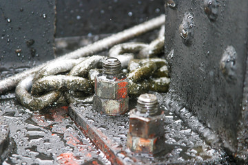 Steam locomotive details on a rainy, snowy day