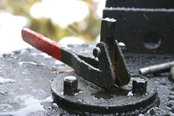 Steam locomotive details on a rainy, snowy day