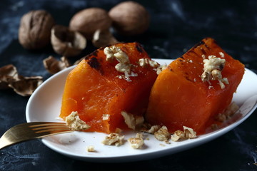 Traditional Turkish pumpkin dessert on a black background
