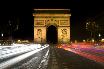Paris triumphal arch illuminated at night, Étoile Arch, with car light trails