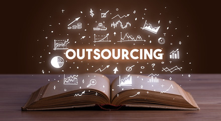 OUTSOURCING inscription coming out from an open book, business concept