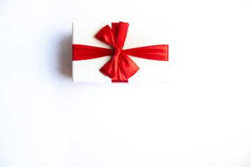 Beautiful Christmas gift box with red ribbon on isolated background. Happy New Year and merry christmas.