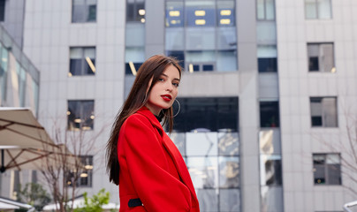 Obraz premium Charming stunning elegant girl black golf and a red autumn coat looks sexy and tender in the frame