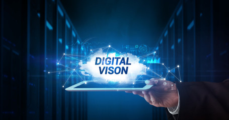 Young business person working on tablet and shows the inscription: DIGITAL VISON