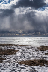 a dramatic picture of streams of light coming through rain clouds