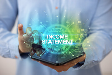 Businessman holding a foldable smartphone with INCOME STATEMENT inscription, new business concept