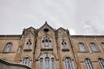 Fototapeta premium Aged old building facade with multiple windows. Historical city elements. European architecture