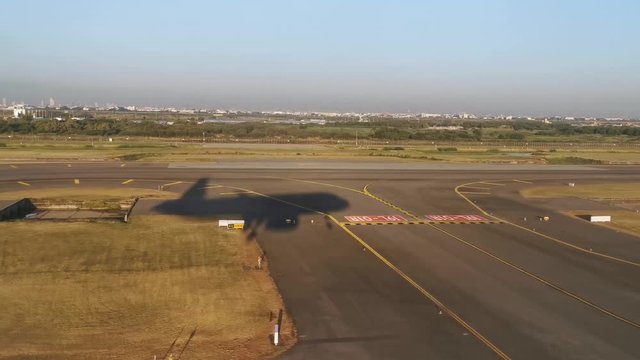 Shadow of airplane landing at the airport, Silhouette of airplane over field