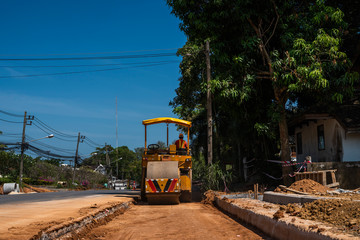 Fototapeta na wymiar Road rollers working on the new roads construction site. Heavy duty machinery working on highway. Construction equipment. Compaction of the road.