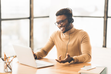 Cheerful consultant with headset speaking to customer