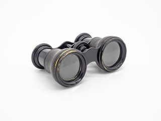 Antique opera glasses isolated on white background. Black small vintage binoculars.