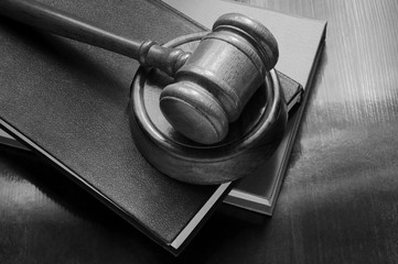 Judge gavel and legal books on wooden table, law and court concept