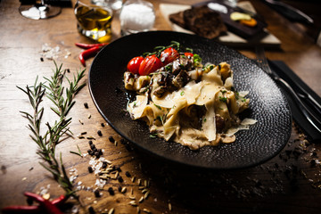 Black Angus Pasta served in a black bowl in restaurant
