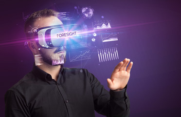 Businessman looking through Virtual Reality glasses with FORESIGHT inscription, new business concept