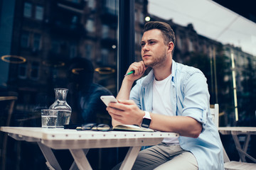 Trouble man surfing on smartphone in city