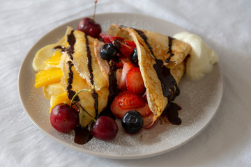 Crepes with Fresh Berries, Chocolate Sauce and Powdered sugar