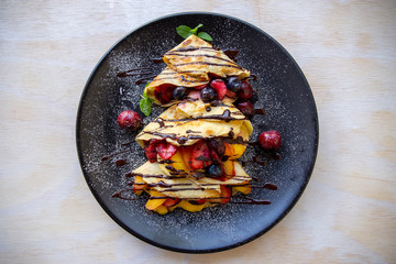 Crepes with Fresh Berries, Chocolate Sauce and Powdered sugar