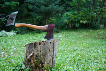 Hatchet lodged into an old wood chopping black