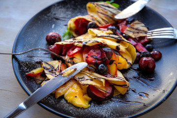 Crepes with Fresh Berries, Chocolate Sauce and Powdered sugar