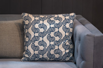 Modern white fabric pillows checkered pattern on gray fabric sofa interior decoration