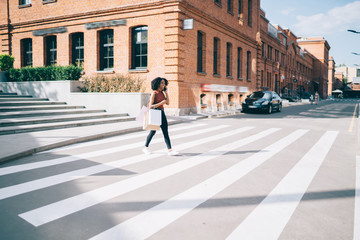 African American woman going on pedestrian crossing