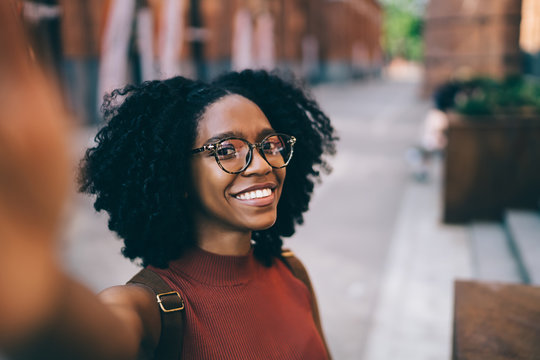 Young Smiling Black Woman Taking Selfie In Street