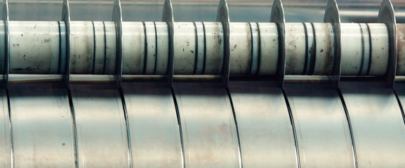 Steel sheets rolled up into rolls.